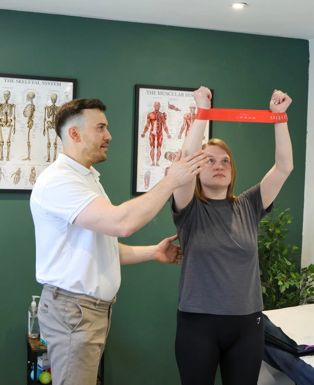 Josh Devine working on a patient's shoulder